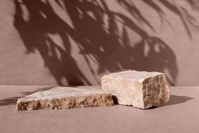 Podium for product promotion and cosmetics.  background for product.  stone, shadow of leaf.  mockup