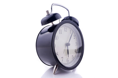 Close-up of alarm clock against white background