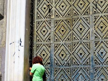 Rear view of woman against building