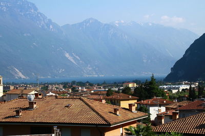 High angle view of townscape by sea against sky