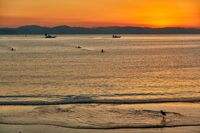 Scenic view of sea against orange sky