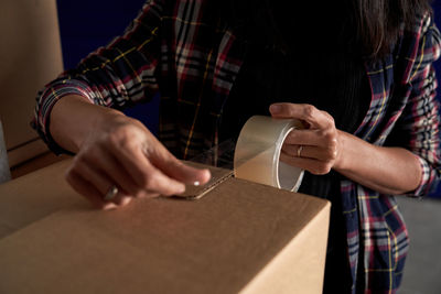 Midsection of woman working on paper