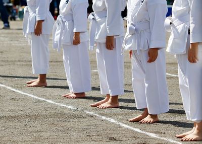 Low section of children standing during martial arts event