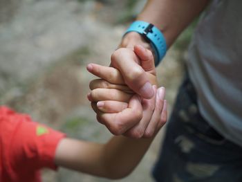 Midsection of father holding hands