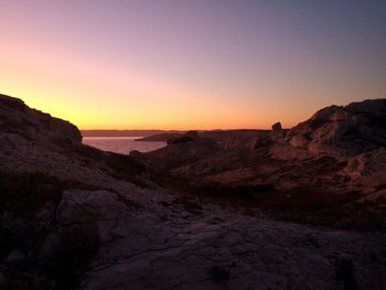 Scenic view of rocky mountains against sky during sunset