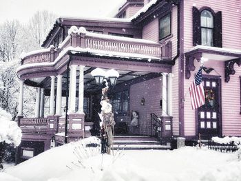 Snow covered trees and buildings during winter