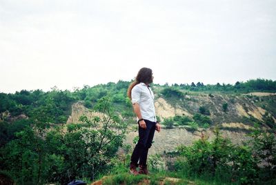 Rear view of woman standing on landscape