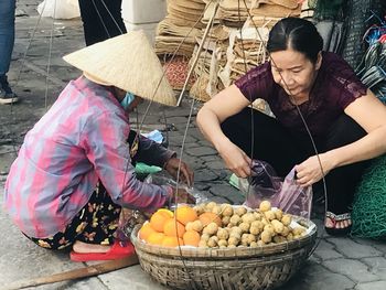 Midsection of man with vegetables in market stall