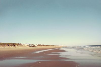 Scenic view of beach against clear sky