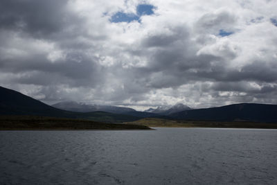 Scenic view of land and mountains against sky