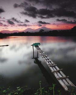 Scenic view of lake against sky at sunset