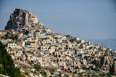 Buildings in city against clear sky