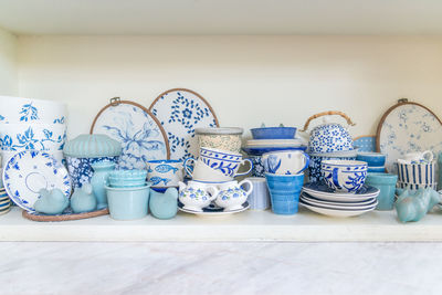 View of crockery on shelf at home