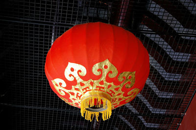 Low angle view of illuminated lantern hanging on ceiling