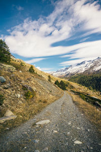 Road amidst land against sky