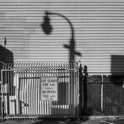 Text on metal fence with city in background