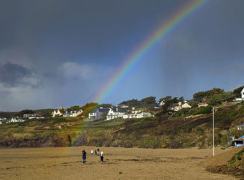 Scenic view of rainbow over mountain against sky