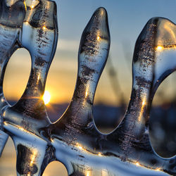 Close-up of metal sculpture during winter against sky