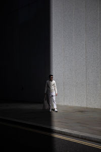 Full length of man standing against wall in building