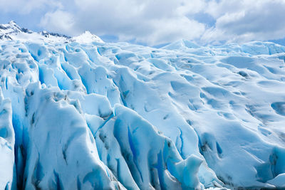 Snow covered landscape against sky