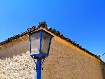 Low angle view of old building against clear blue sky