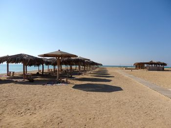 Scenic view of beach against blue sky