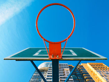 Low angle view of basketball hoop against blue sky