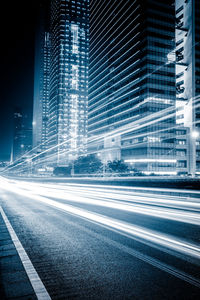 View of light trails on city street at night