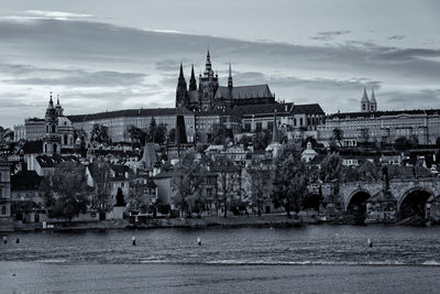 Buildings by river in city