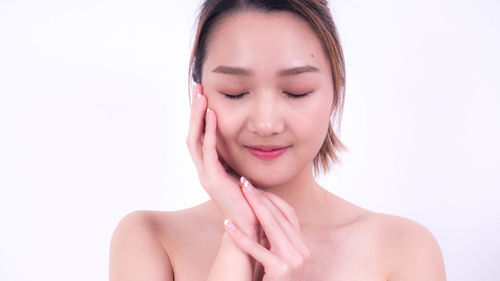 Portrait of a beautiful young woman over white background
