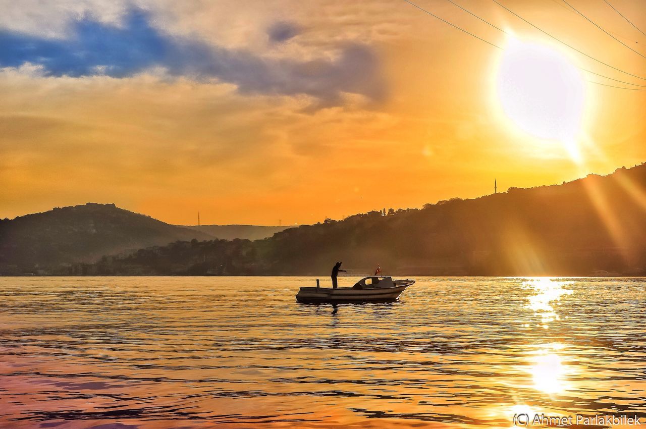 sunset, sun, water, nautical vessel, transportation, waterfront, mountain, scenics, boat, tranquil scene, tranquility, beauty in nature, silhouette, mode of transport, reflection, orange color, sky, sunlight, sunbeam, nature