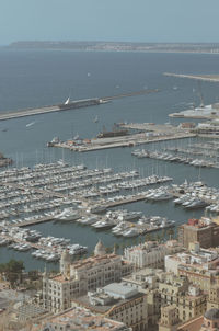 High angle view of townscape by sea against sky