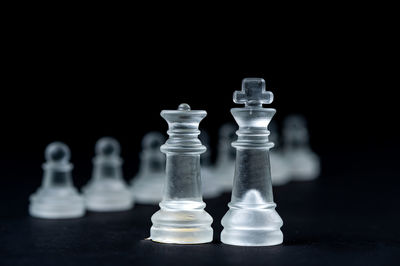 Close-up of chess pieces against black background