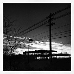 Low angle view of electricity pylon against sky