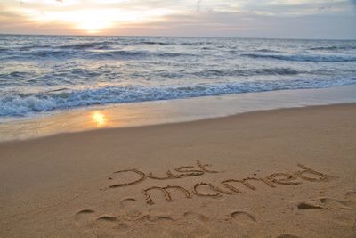 Scenic view of beach against sky during sunset