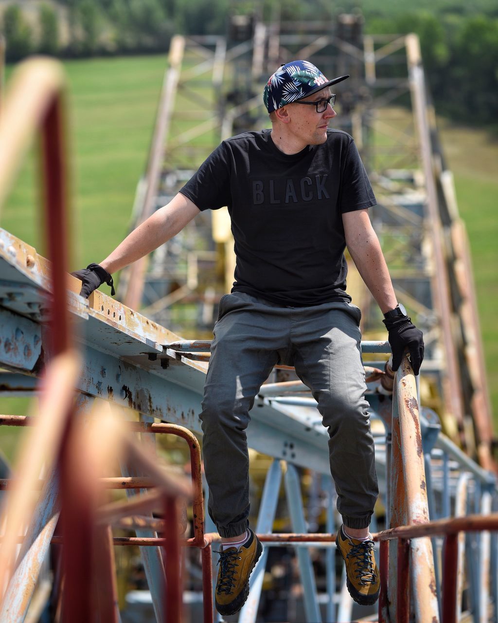 real people, one person, full length, casual clothing, men, leisure activity, day, front view, sport, lifestyles, selective focus, helmet, metal, protection, young men, security, outdoors, males, teenager