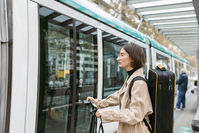 Woman looking through train window