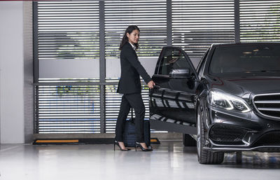 Full length of woman standing on car