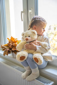 Portrait of young woman with teddy bear