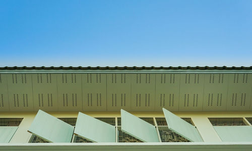 Low angle view of building against clear blue sky