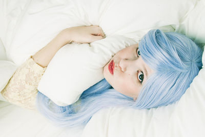 Close-up portrait of a girl lying on bed