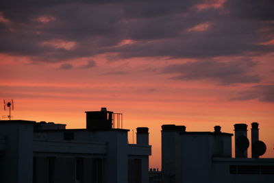 Silhouette buildings against sky during sunset