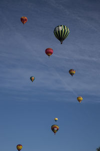 Low angle view of hot air balloons flying in sky