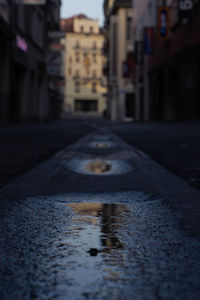 Empty road in city with water reflection