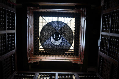 Directly below shot of lantern hanging in historic building