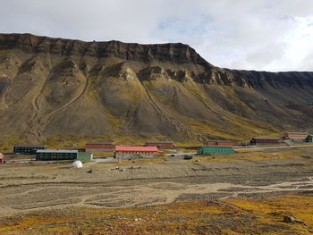 Scenic view of land and mountains against sky