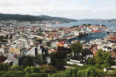 High angle view of townscape by sea against sky