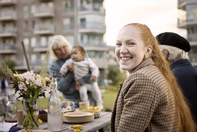 Smiling woman at table looking at camera