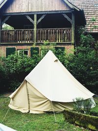 Tent on field by building