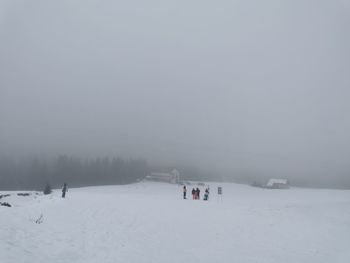 Scenic view of snow covered field against sky